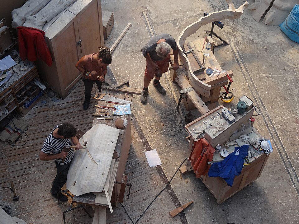 Makers at work in the workshop, seen from the gallery above
